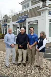Four members of the Almeida & Carlson team outside the agency office